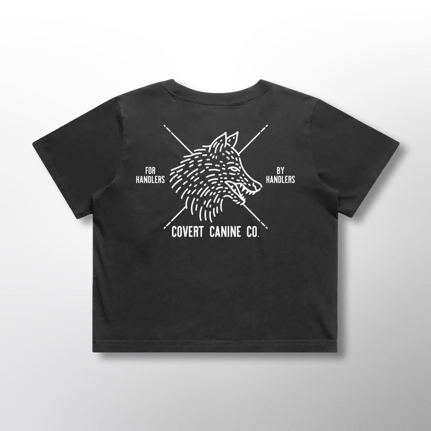Back of black crop top with white Covert Canine Co. logo and text on a light gray background