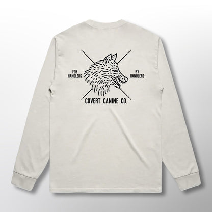 Back of a white long-sleeve shirt with black Covert Canine Co. logo and text on a white background