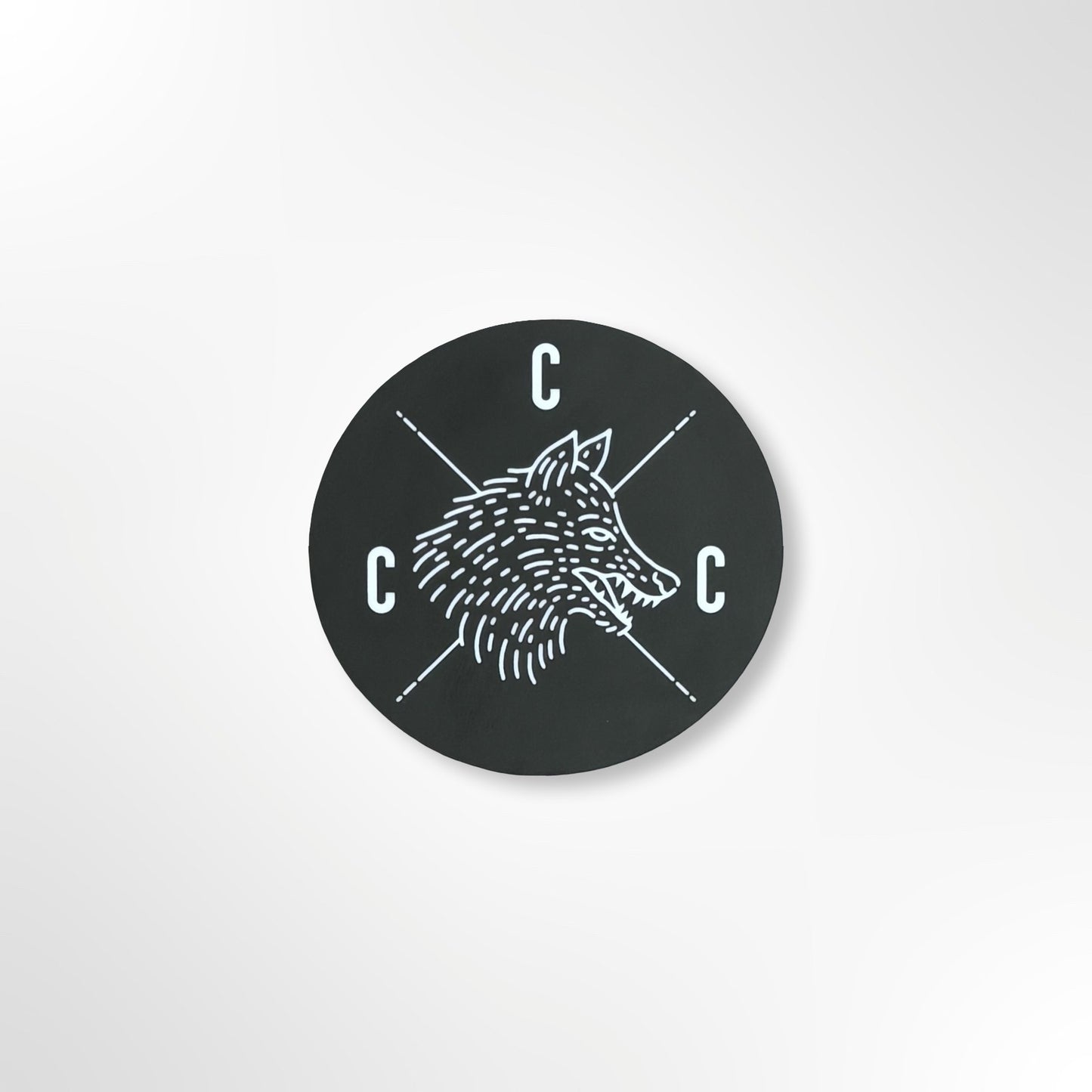 Black circular sticker with a Covert Canine Co. logo and 'C' letters on a black background