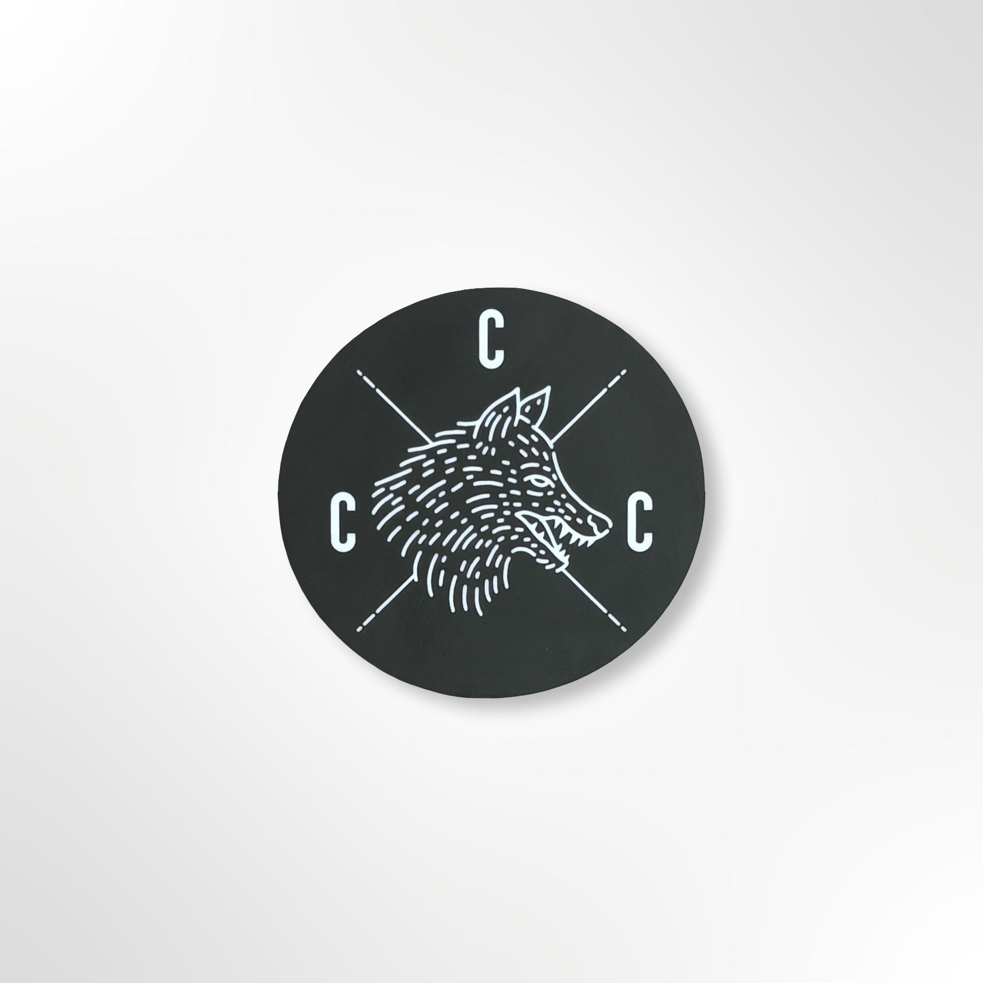 Black circular sticker with a Covert Canine Co. logo and 'C' letters on a black background