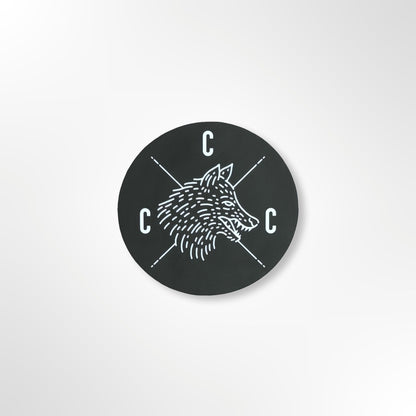 Black circular sticker with a Covert Canine Co. logo and 'C' letters on a black background