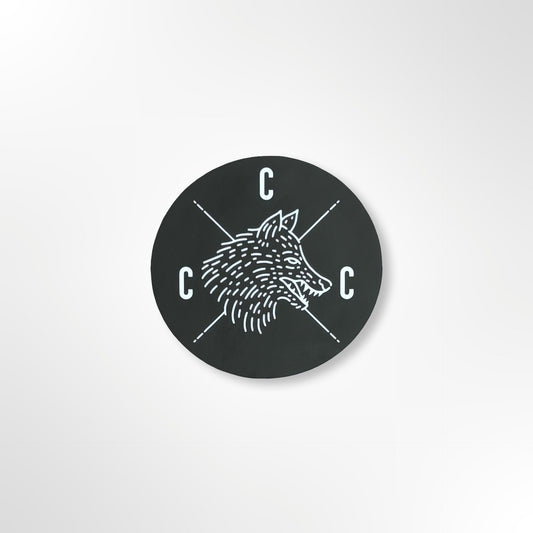 Black circular sticker with a Covert Canine Co. logo and 'C' letters on a black background