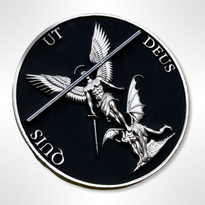 Circular emblem with winged figure and bat-like creature, featuring Latin text on a black background.