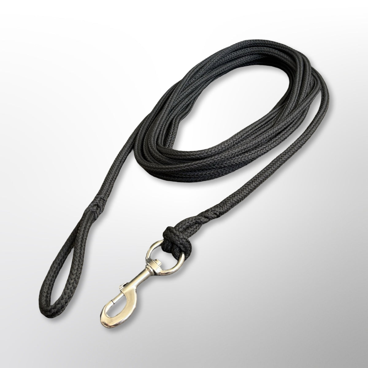 Coiled Covert Canine Co. rope tracking line with stainless steel snap hook and spliced handle