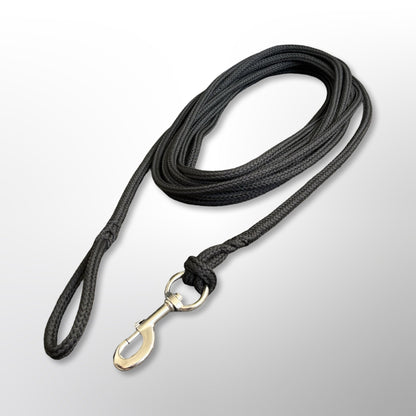 Coiled Covert Canine Co. rope tracking line with stainless steel snap hook and spliced handle