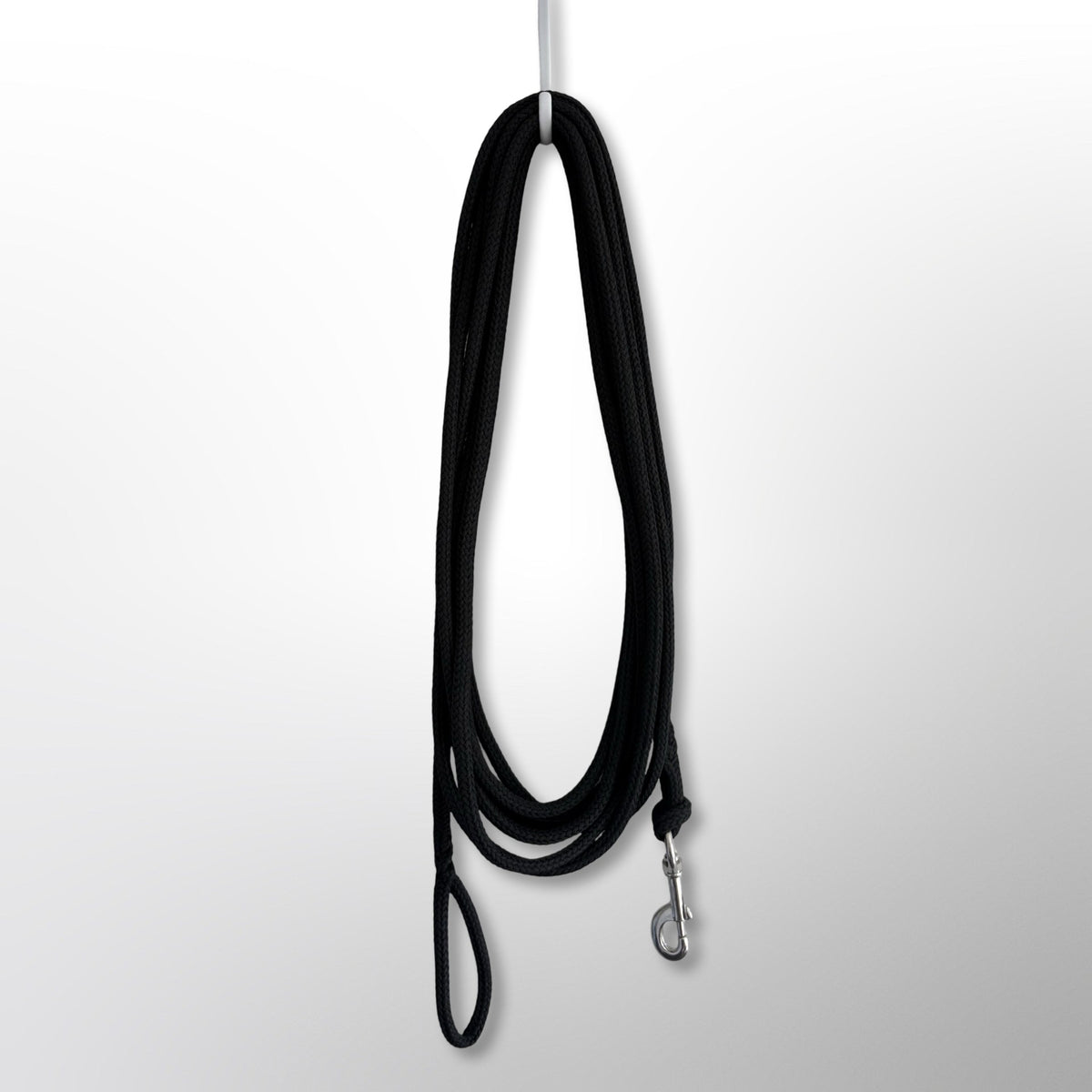 Covert Canine Co. rope tracking line hanging, showing full length, spliced handle and stainless snap hook
