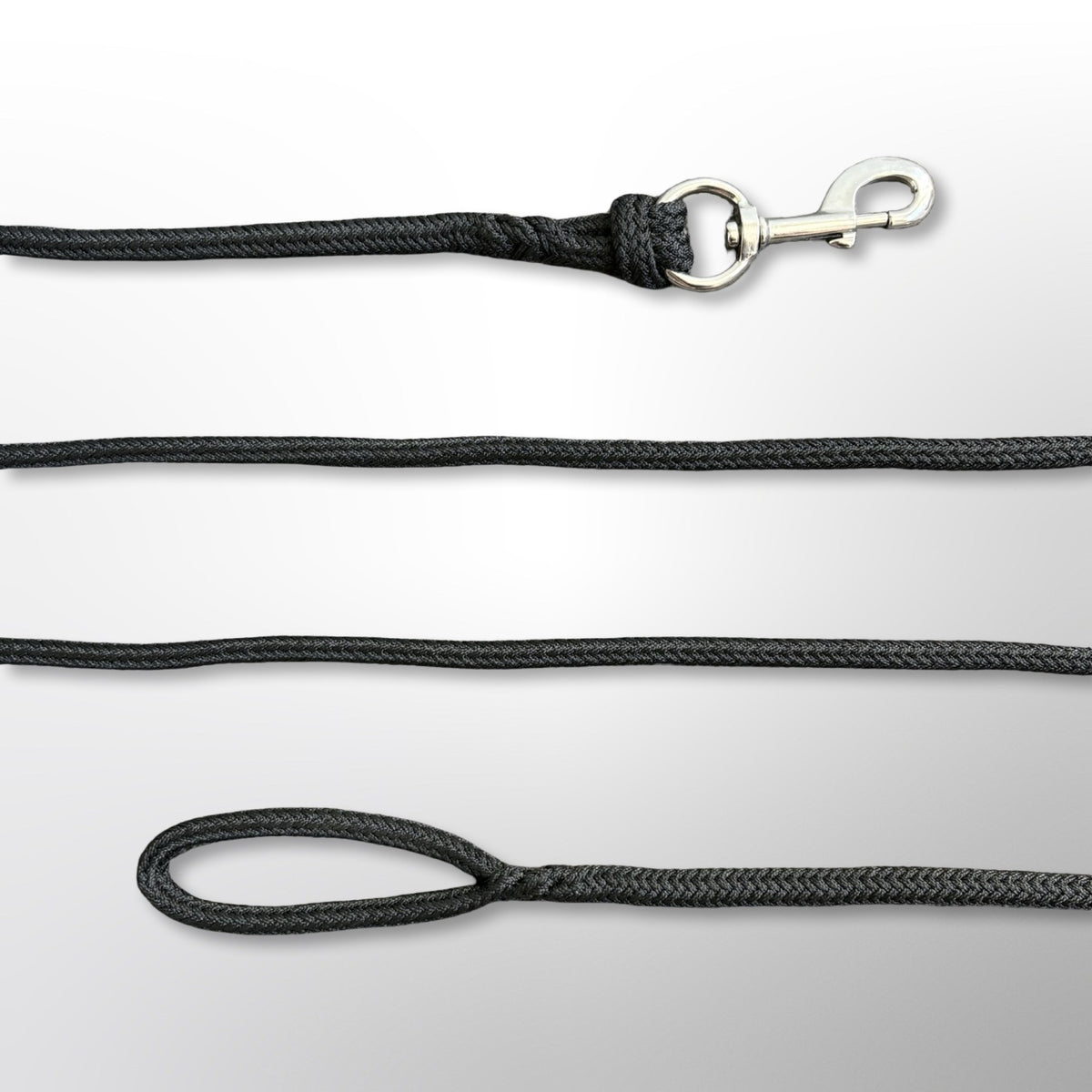Close-up of the hand-spliced ends of a Covert Canine Co. rope tracking line, showing the snap hook and loop handle