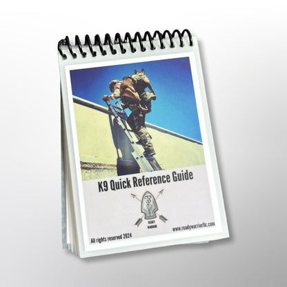 Front cover of the Ready Warrior K9 Quick Reference Guide, a spiral-bound, laminated pocket guide, showing a handler carrying a K9 up a ladder